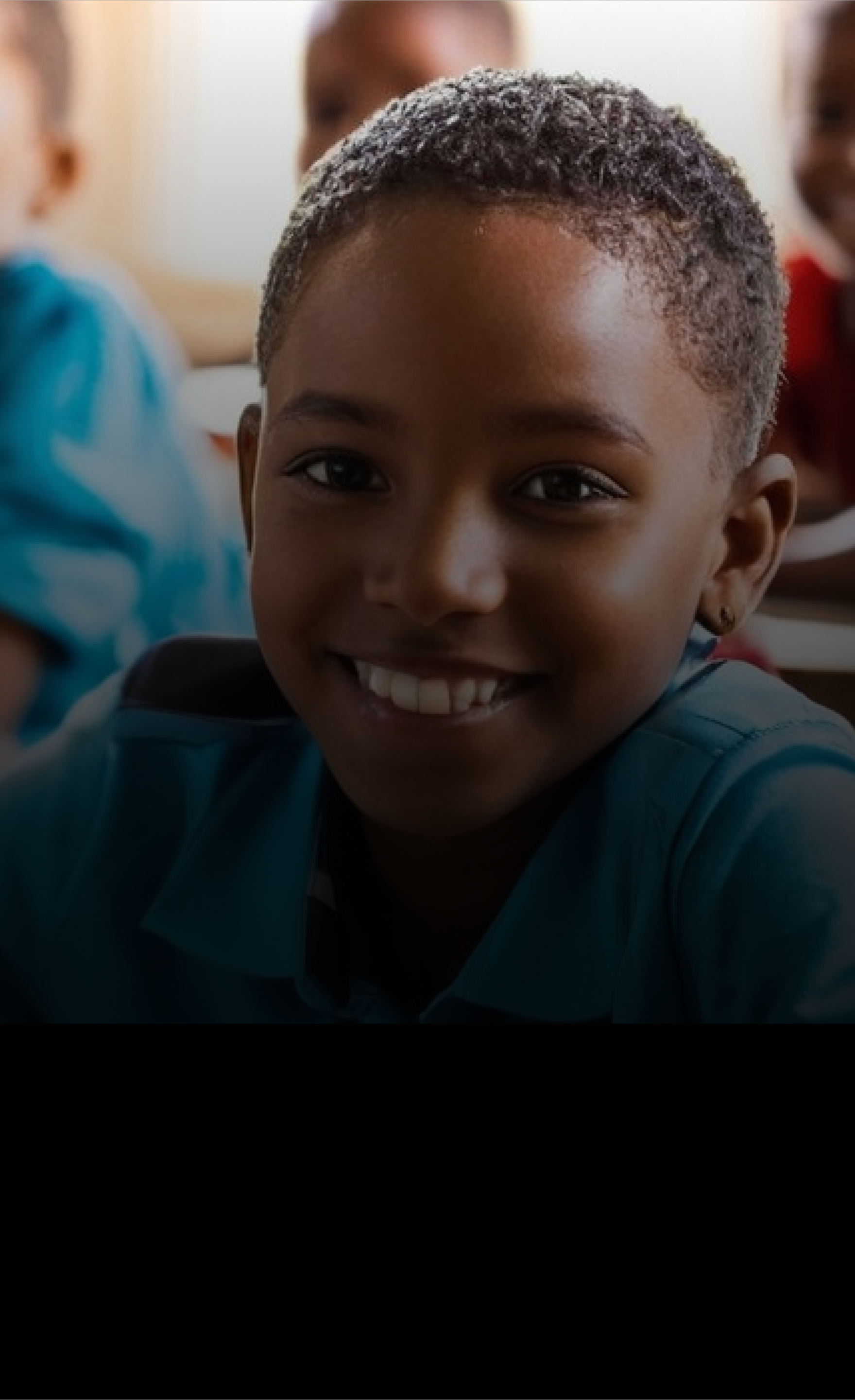 Child smiling in a classroom